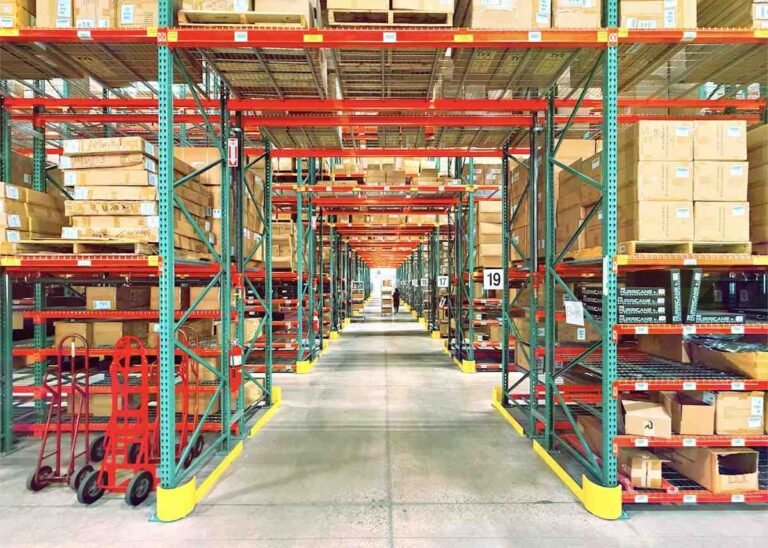 Costco interview questions prep: tall warehouse racking stacked with boxed inventory along a wide aisle