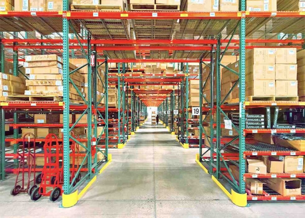 Costco interview questions prep: tall warehouse racking stacked with boxed inventory along a wide aisle