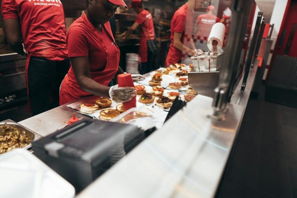 Fast food crew preparing orders on a line, the kind of team the Chick-fil-A hiring process is built to staff