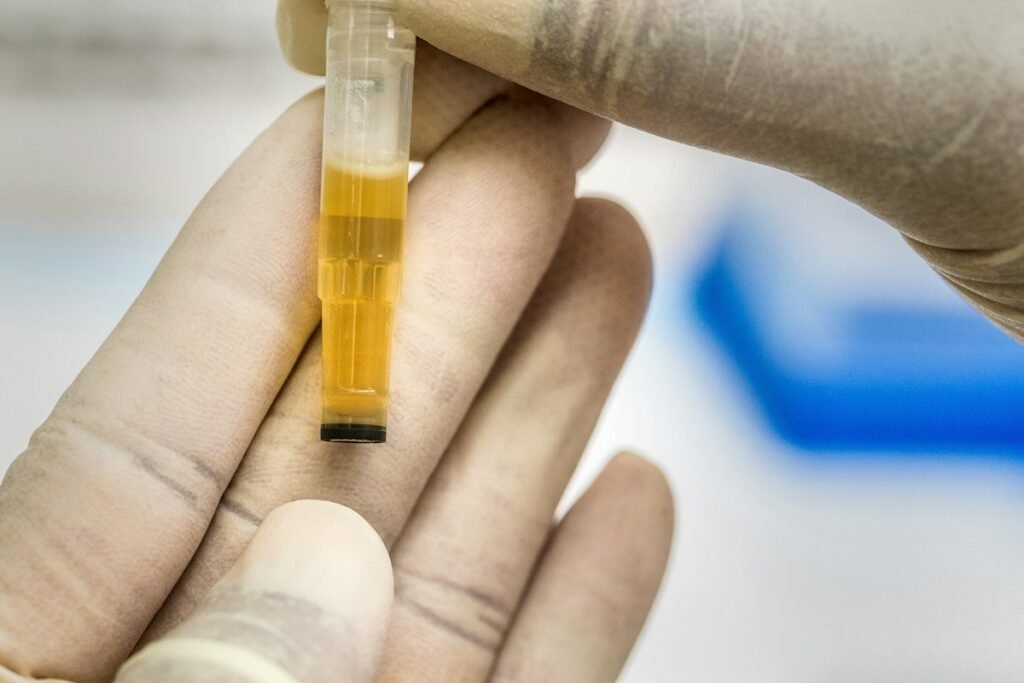 Does Target drug test applicants: a urine sample vial held up by a gloved lab technician