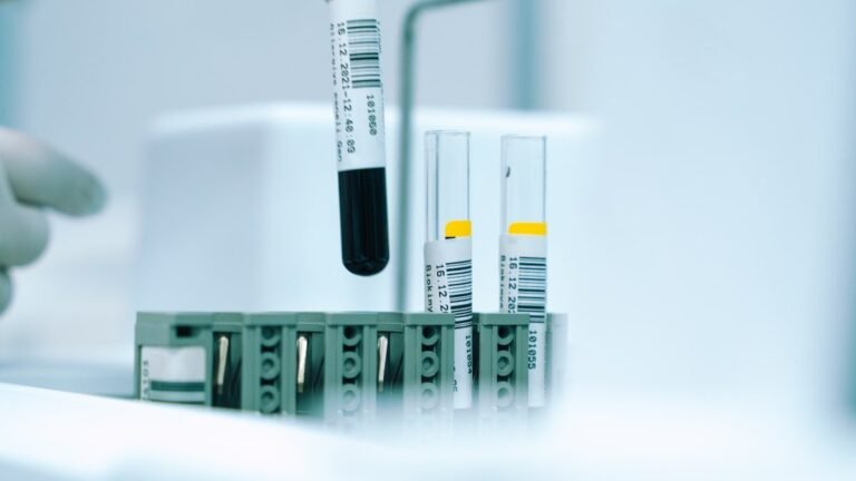 Lab technician handling specimen tubes for a Walmart drug test screening at a third-party clinic