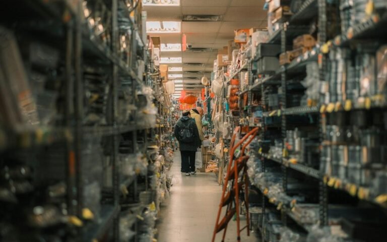Customers in a hardware store aisle, the setting the Home Depot assessment test asks you to picture
