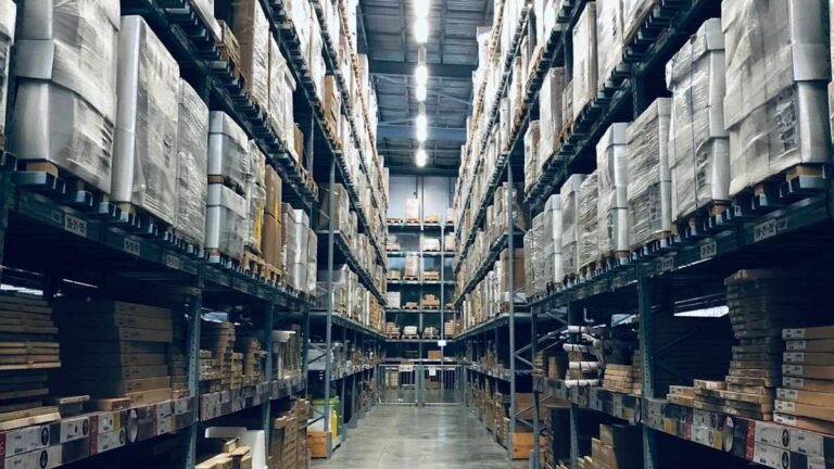 Does Costco drug test warehouse hires: a tall pallet-racking aisle inside a big-box warehouse
