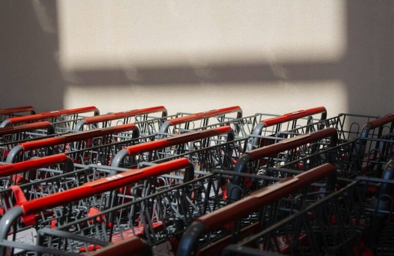 Rows of red shopping carts outside a warehouse club, the entry point for seasonal jobs at Costco