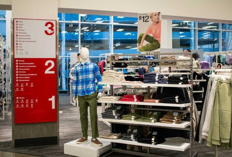 Folded apparel stacks and floor directory inside a Target store, where most Target seasonal jobs are based